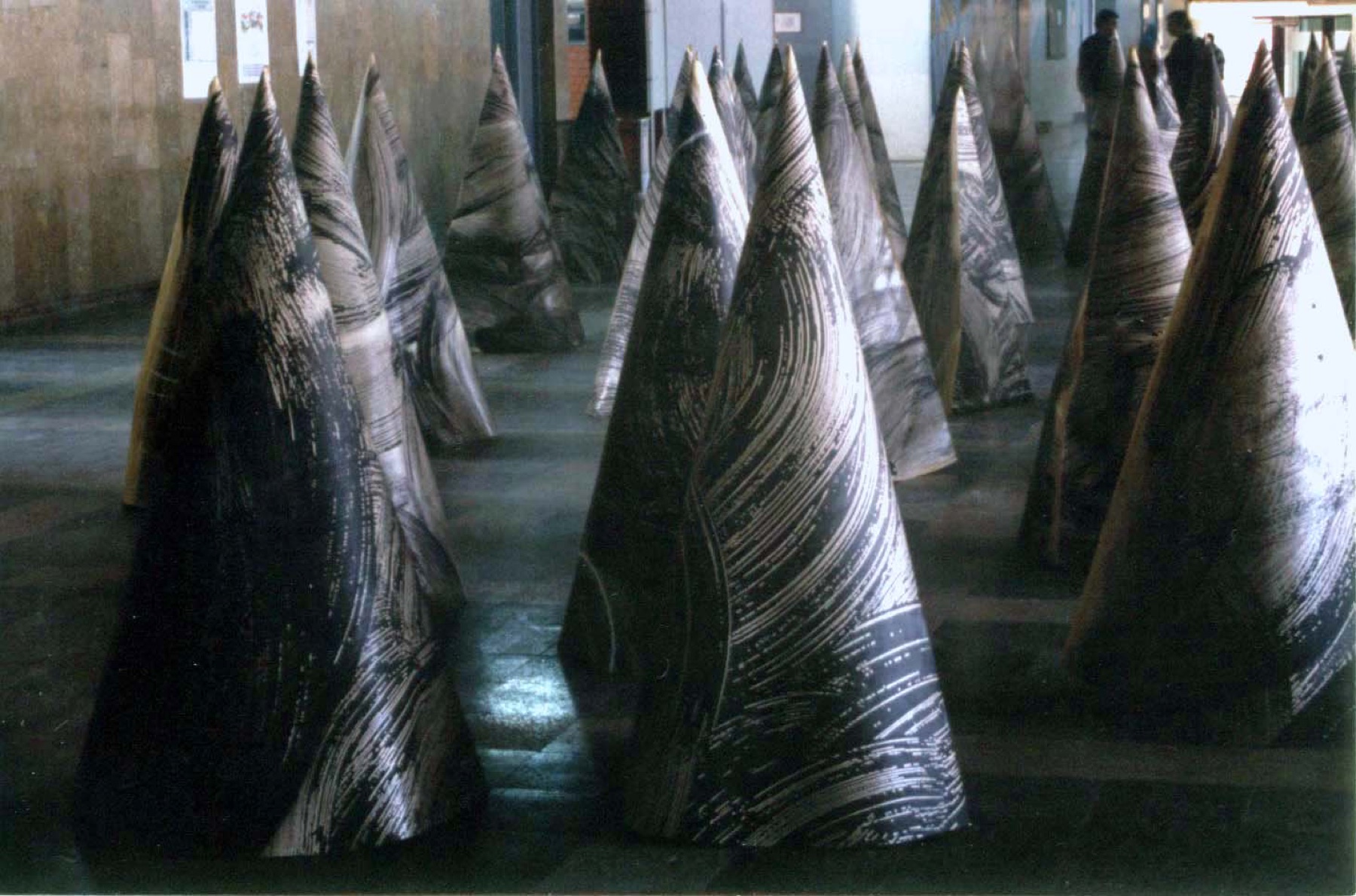 Black paper cone installation in a hallway