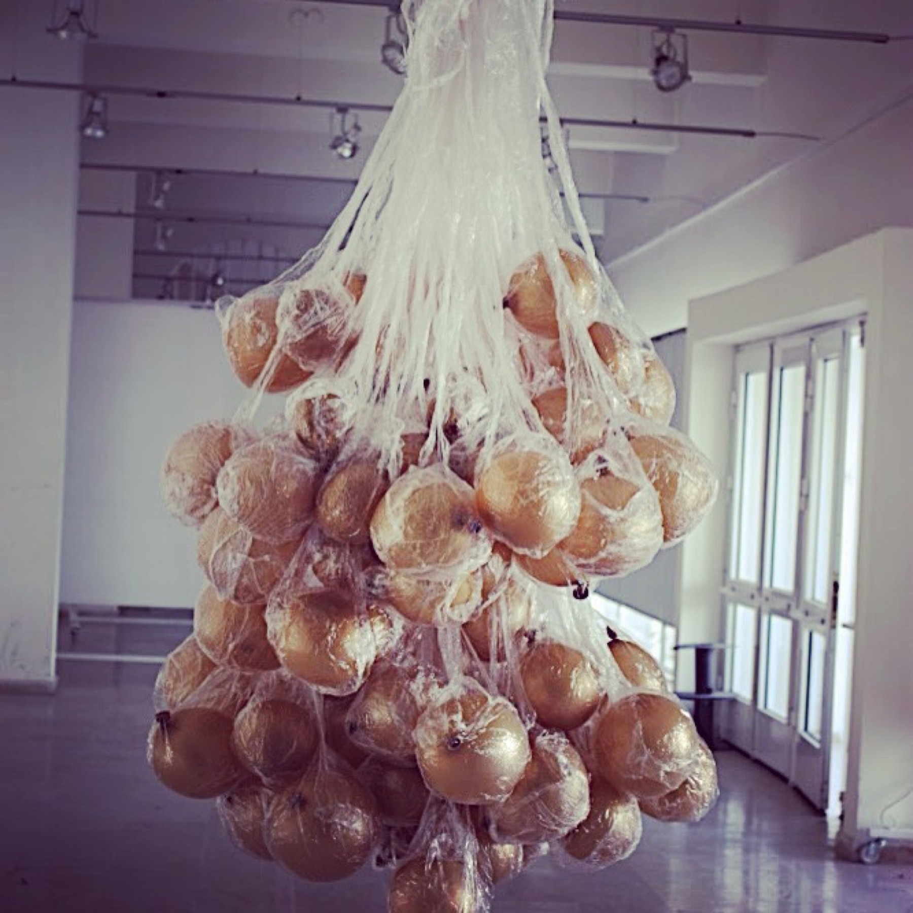 Hanging bundles of gilded paper objects