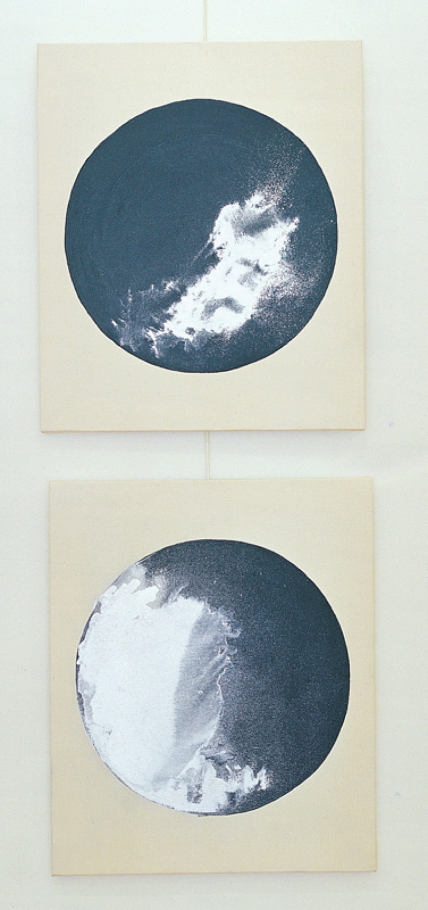 Two circular navy and white prints on paper